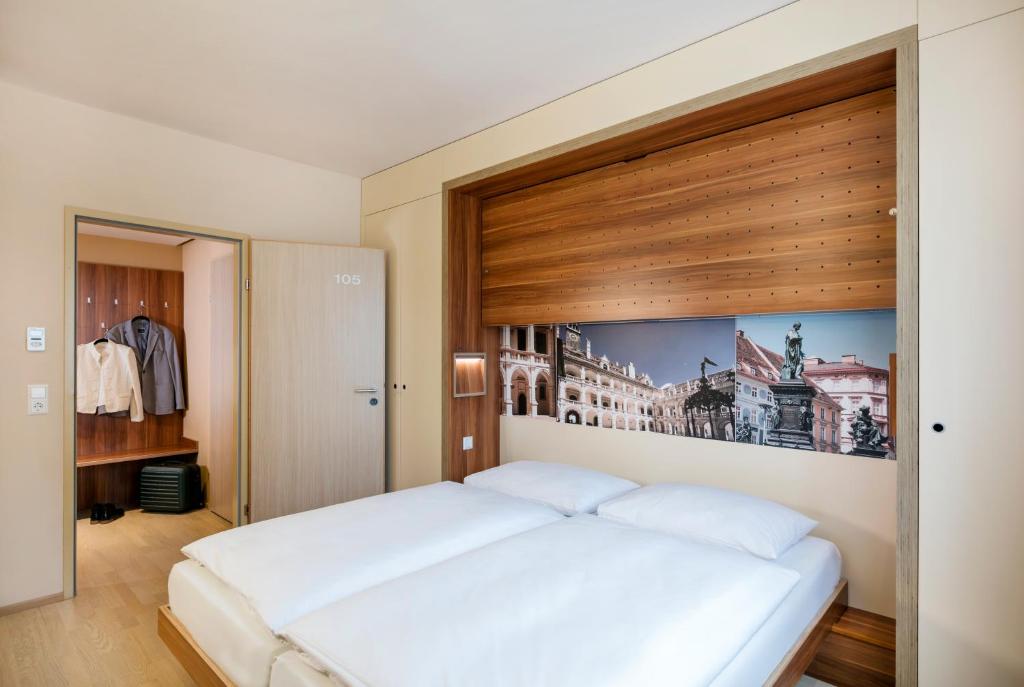 Postel nebo postele na pokoji v ubytování JUFA Hotel Graz City