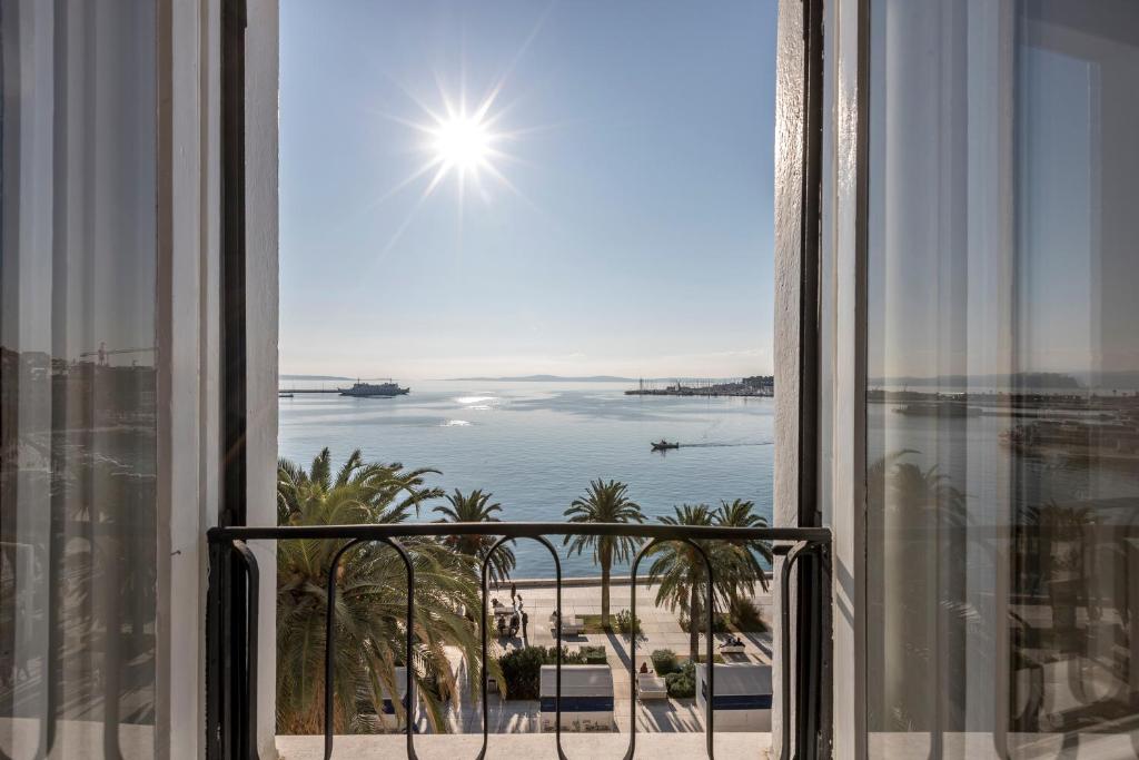 a view of the beach from a room with a window at Olivia Luxury Rooms in Split