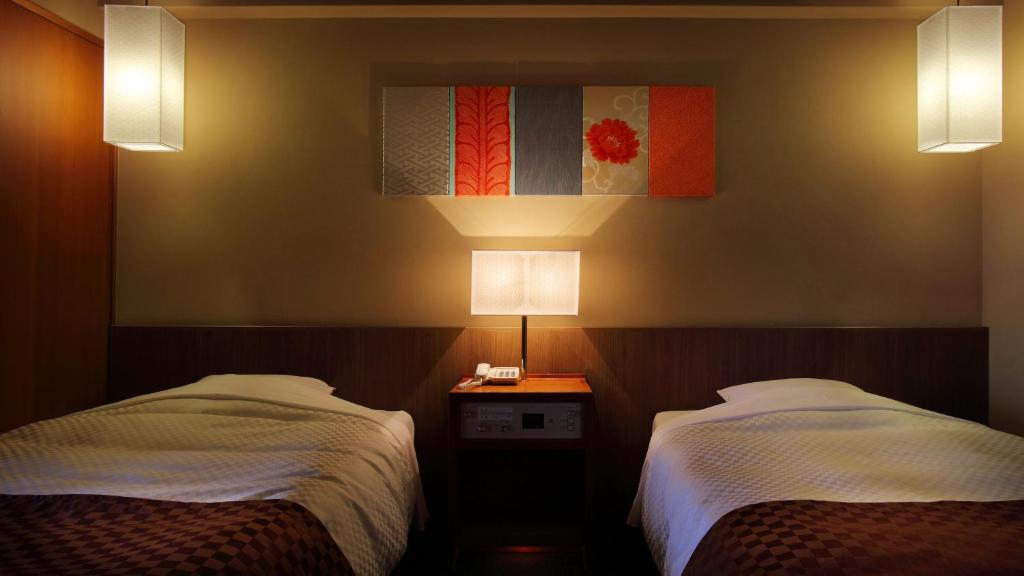 Postel nebo postele na pokoji v ubytování Aki Grand Hotel & Spa