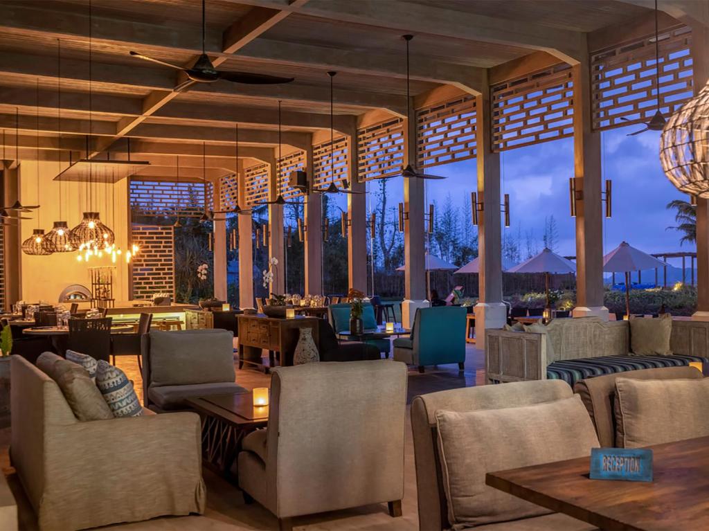 a lobby of a resort with chairs and tables at Selong Selo Resort and Residences in Selong Belanak