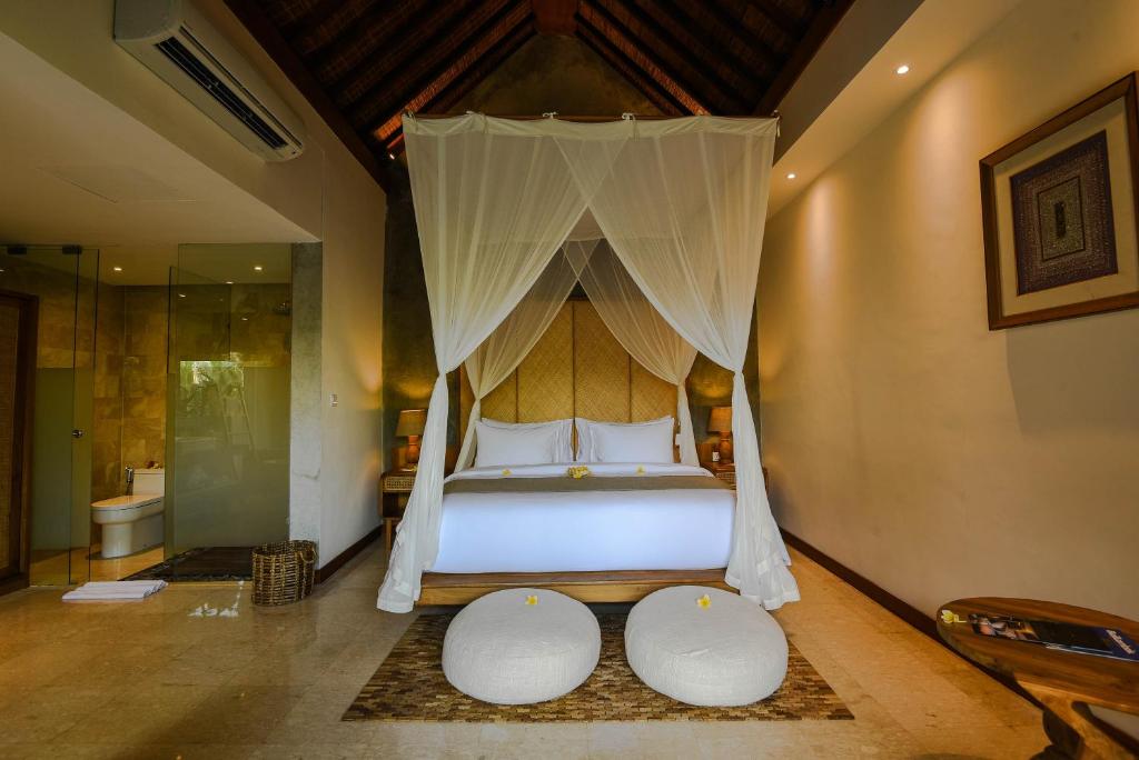 Letto o letti in una camera di Purana Suite Ubud