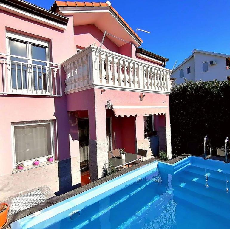a house with a swimming pool in front of a house at House Srima-Vodice Dalmatia in Srima