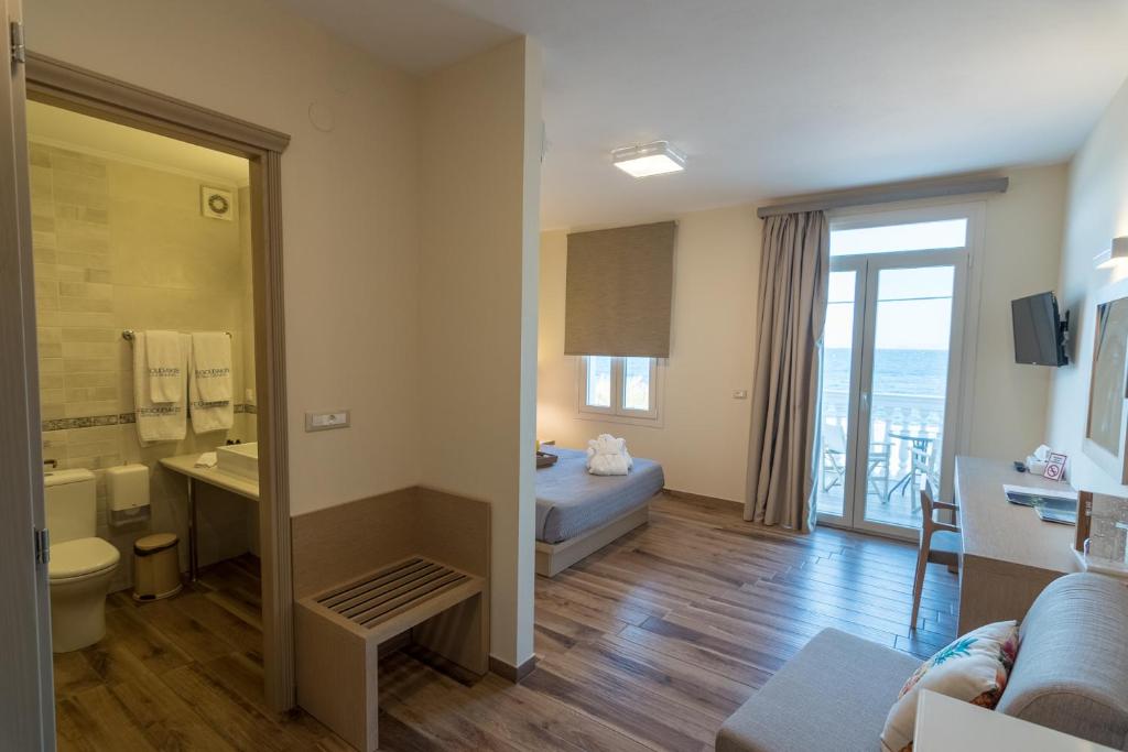a hotel room with a bed and a bathroom at Grecian Castle Chios in Chios