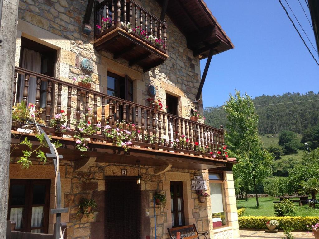 a building with a balcony with flowers on it at Posada el Remanso de Trivieco in La Cavada