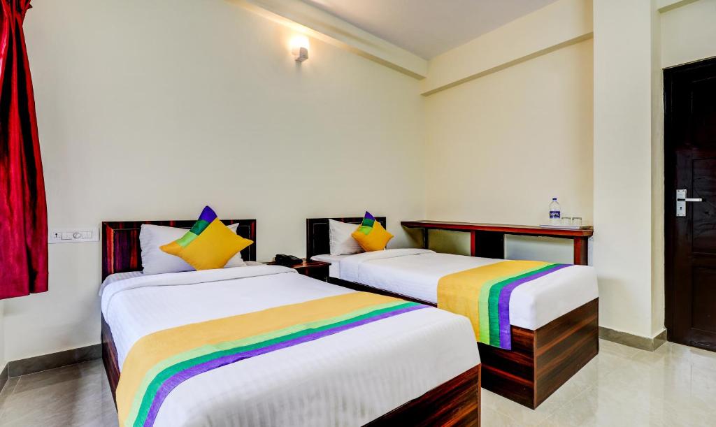 Postel nebo postele na pokoji v ubytování Itsy Hotels Rain Tulsi Stayz, Palarivattom Junction