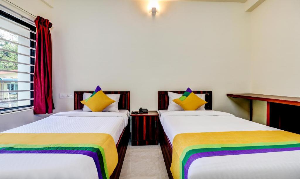 Postel nebo postele na pokoji v ubytování Itsy Hotels Rain Tulsi Stayz, Palarivattom Junction