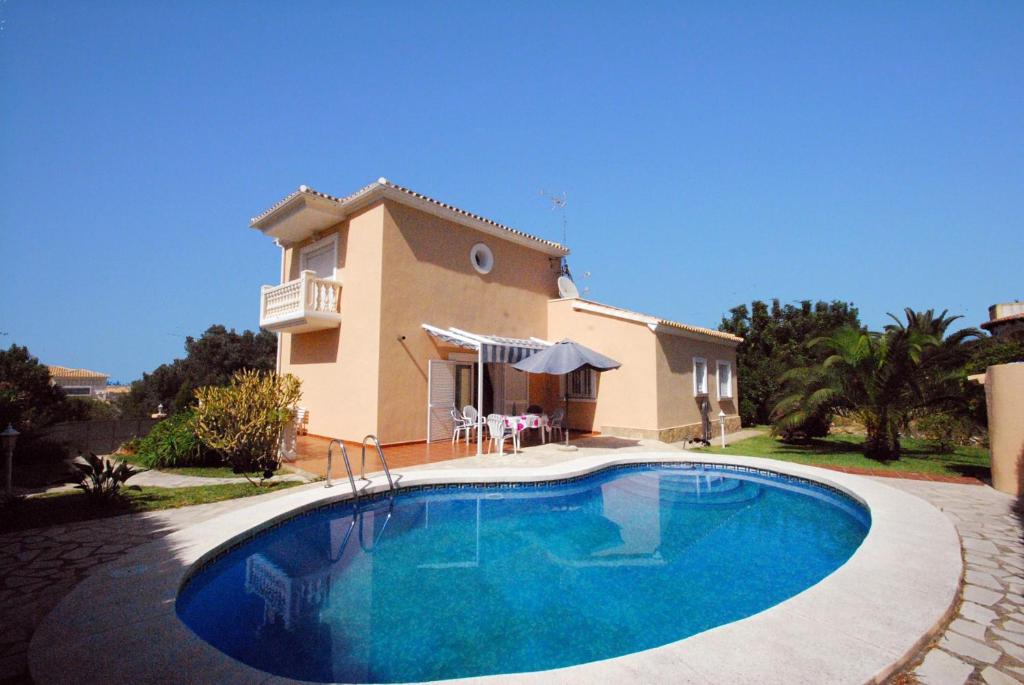 a large swimming pool in front of a house at Villa Bugamvilla - Deniasol in Denia