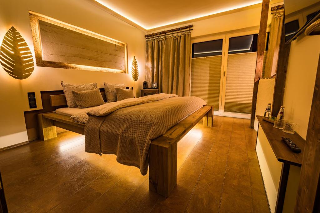 a bedroom with a large bed in a room at Locanda Boutique Hotel in Stollberg