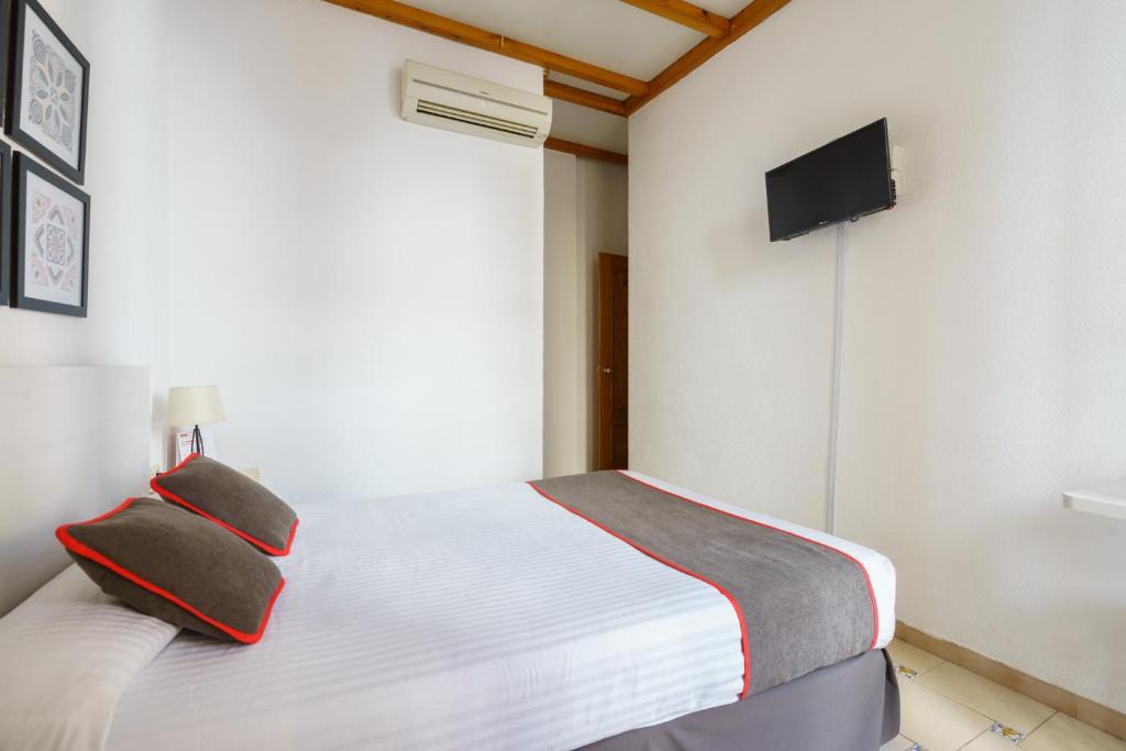 Cama o camas de una habitación en Hostal Austria