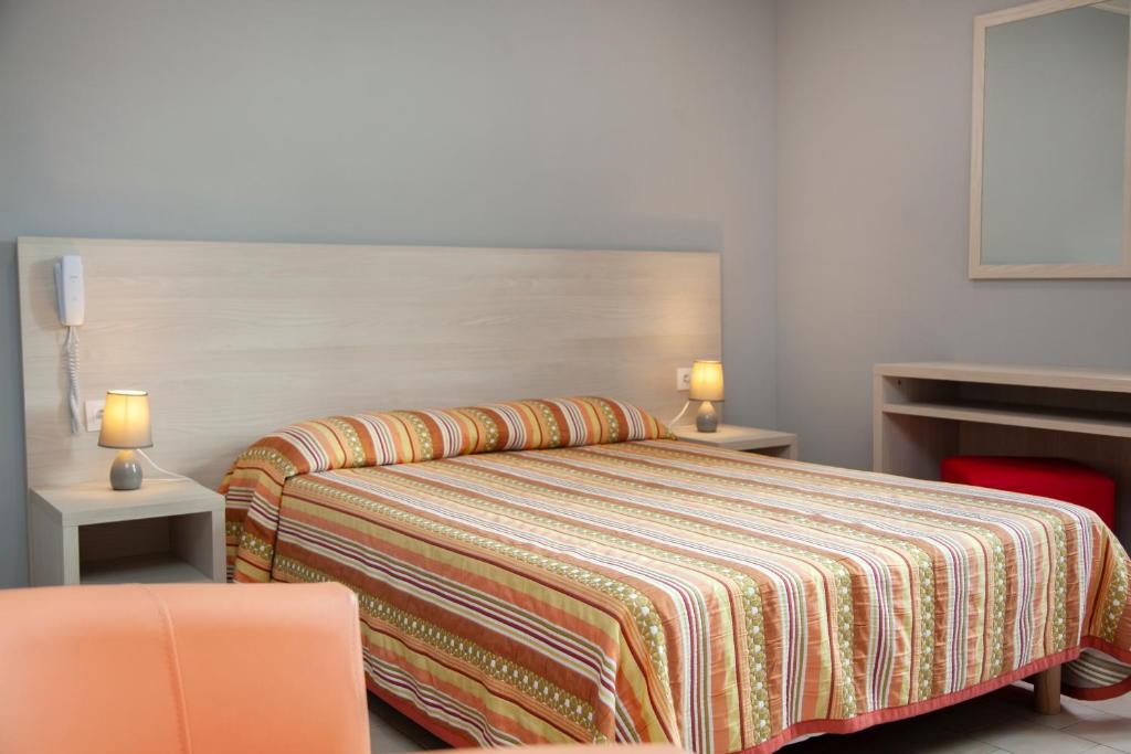 Postel nebo postele na pokoji v ubytování Hotel Arcu Di Sole