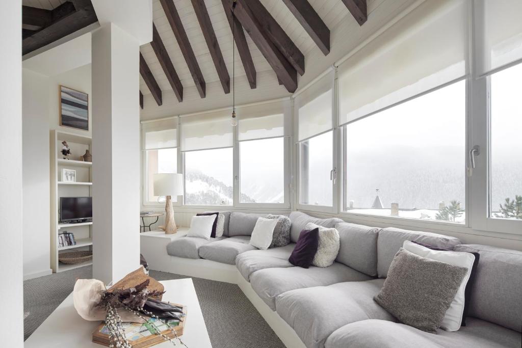 a living room with two couches and large windows at Dossau by FeelFree Rentals in Naut Aran