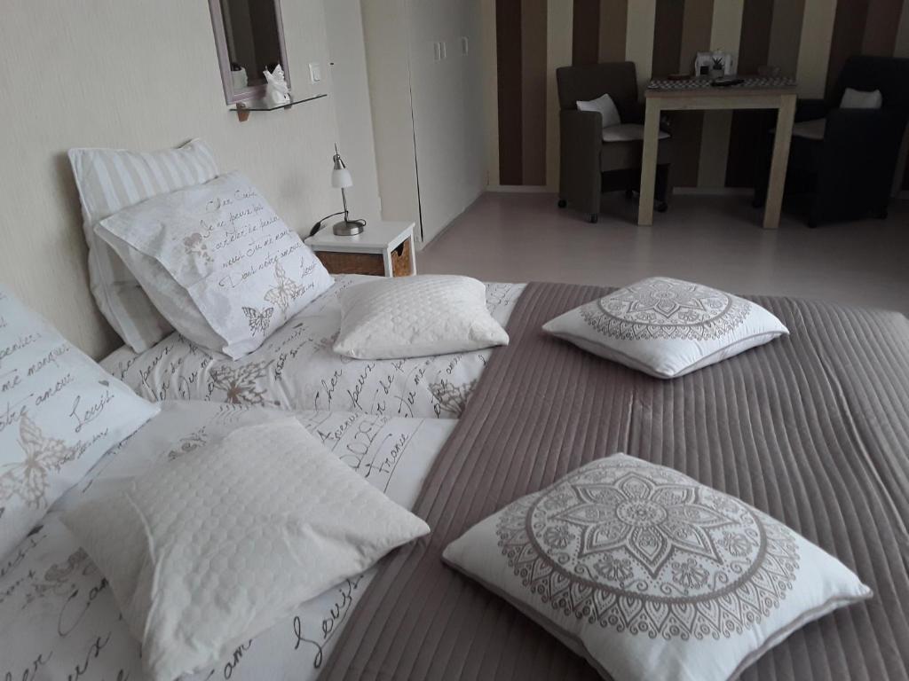 two beds with pillows on them in a room at De Spiegel in Schagen