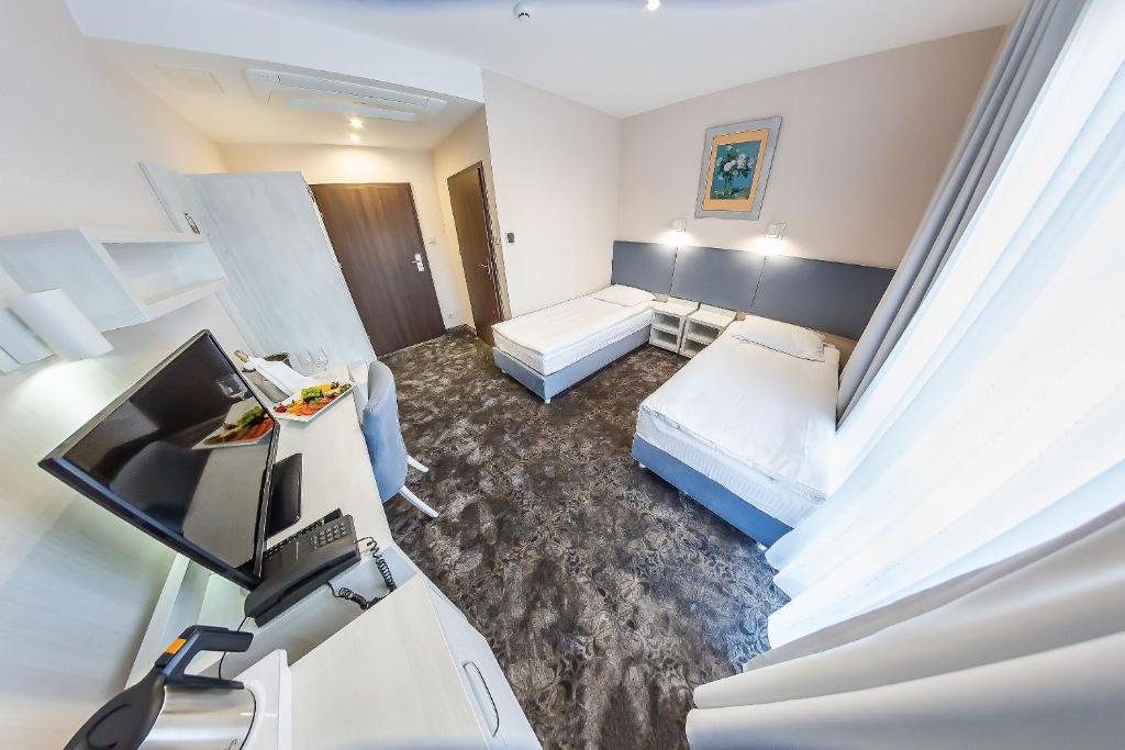 Postel nebo postele na pokoji v ubytování Hotel Jantar Wellness & Spa