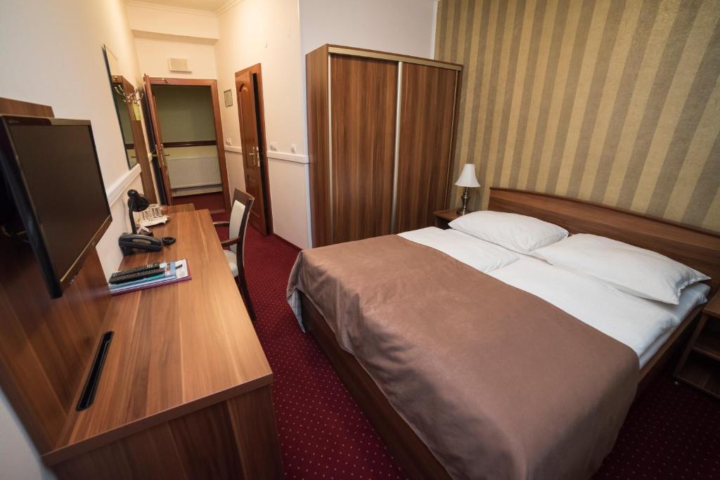 Posteľ alebo postele v izbe v ubytovaní Hotel Alfa