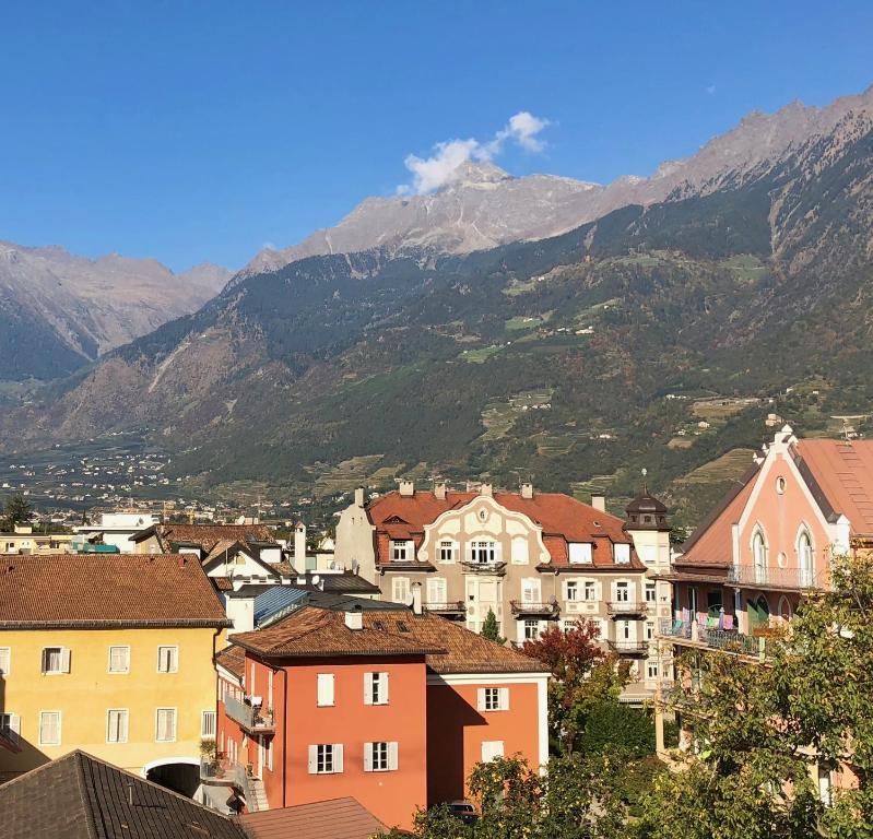 a view of a town with mountains in the background at City Apartments Portico in Merano