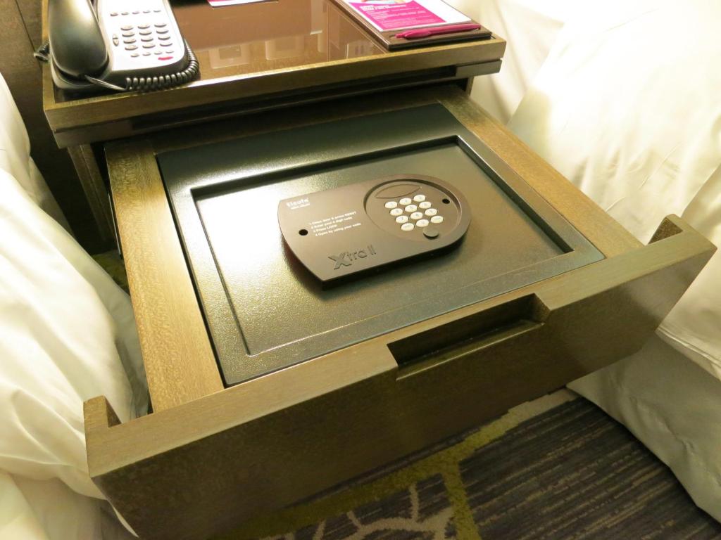 a remote control sitting on top of a bed at Crowne Plaza Hong Kong Kowloon East, an IHG Hotel in Hong Kong