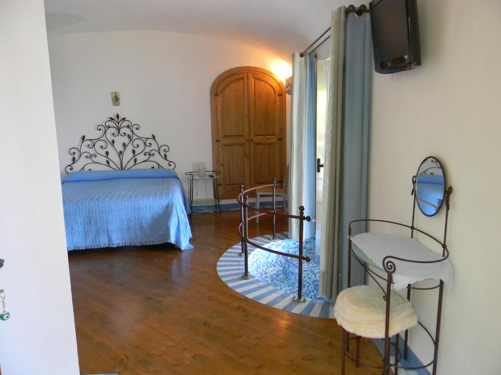 a bedroom with a bed and two chairs at Fattoria La Tagliata in Positano