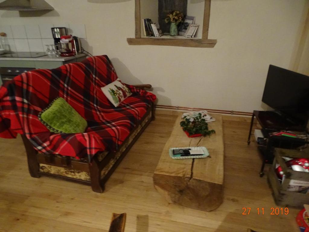 a living room with a couch and a coffee table at L étable au naturel in Mauriac