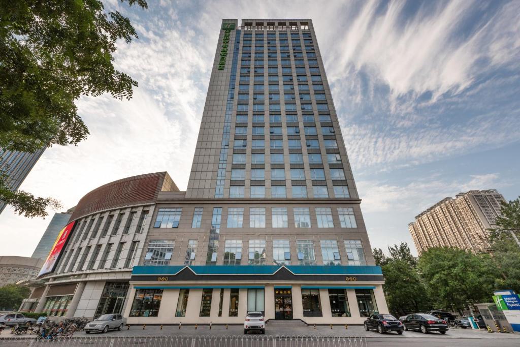 a tall building with cars parked in front of it at Holiday Inn Express Tianjin Heping, an IHG Hotel in Tianjin