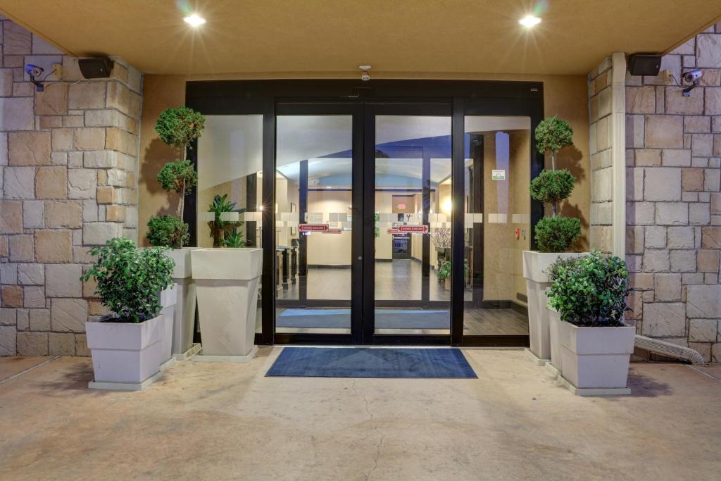 an entrance to a building with a door with potted plants at Holiday Inn Express Hotel & Suites Texarkana East by IHG in Texarkana