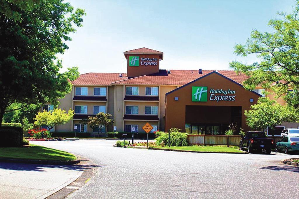 a large building with a sign for a hotel at Holiday Inn Express Portland East - Columbia Gorge, an IHG Hotel in Troutdale