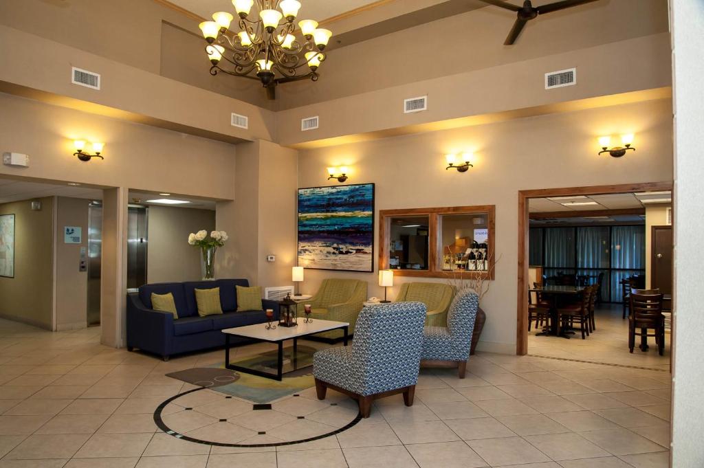 a lobby with a couch and chairs and a table at Holiday Inn Express Tucson-Airport, an IHG Hotel in Tucson