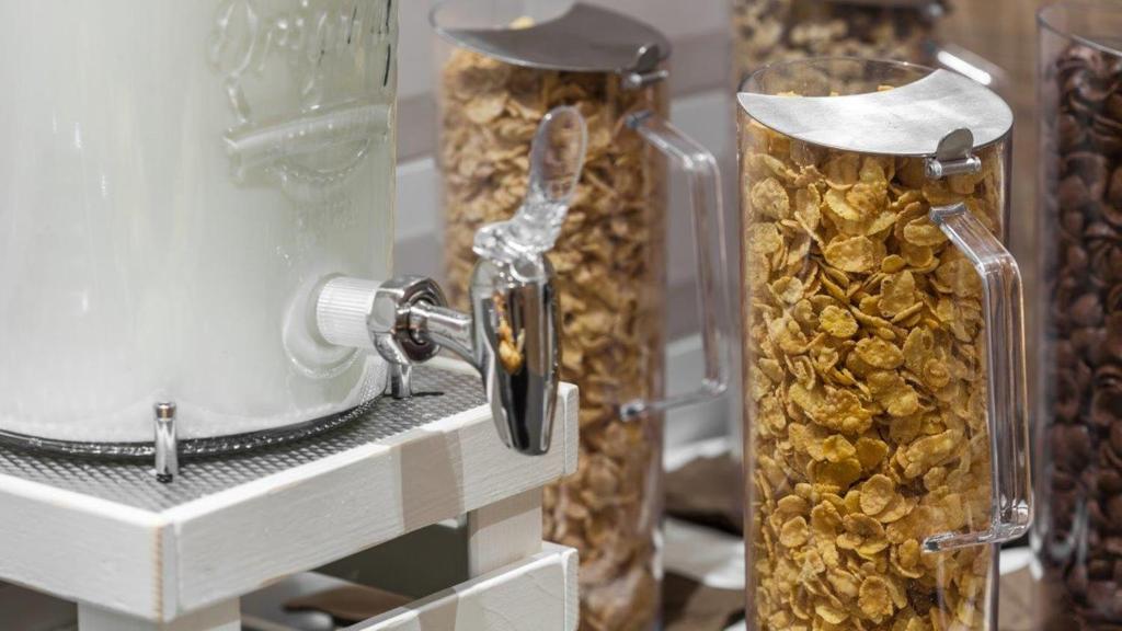 a group of glass jars filled with gold peanuts at Holiday Inn Express - Wuppertal - Hauptbahnhof, an IHG Hotel in Wuppertal