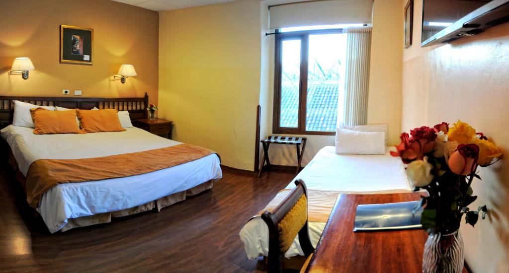 Postel nebo postele na pokoji v ubytování Hotel Real Audiencia
