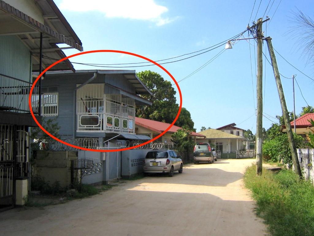 a red circle is on the side of a house at Cosy home for short stay or a weekend getaway in Paramaribo