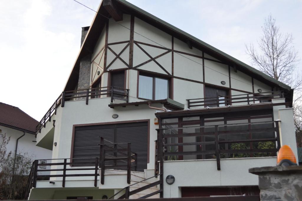 a house with black and white at Ski & Adventure Vila in Azuga