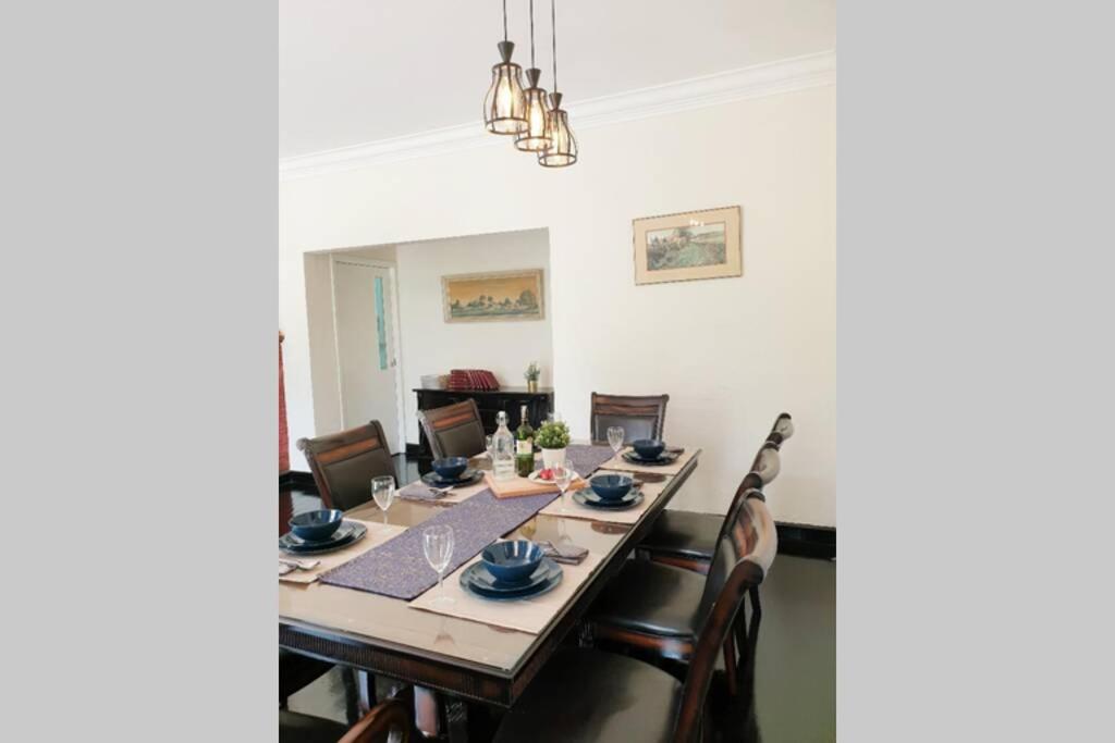 a dining room with a long table and chairs at 9Pax BintangCottage CameronHighlands *星之高原屋* in Cameron Highlands