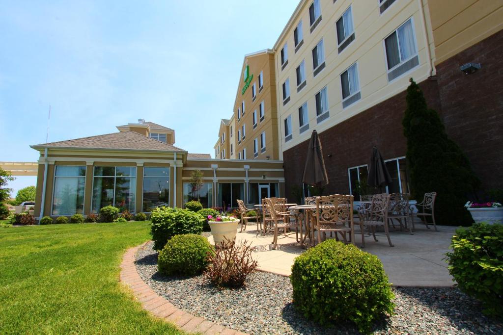 a patio with tables and chairs outside of a building at Holiday Inn Effingham by IHG in Effingham