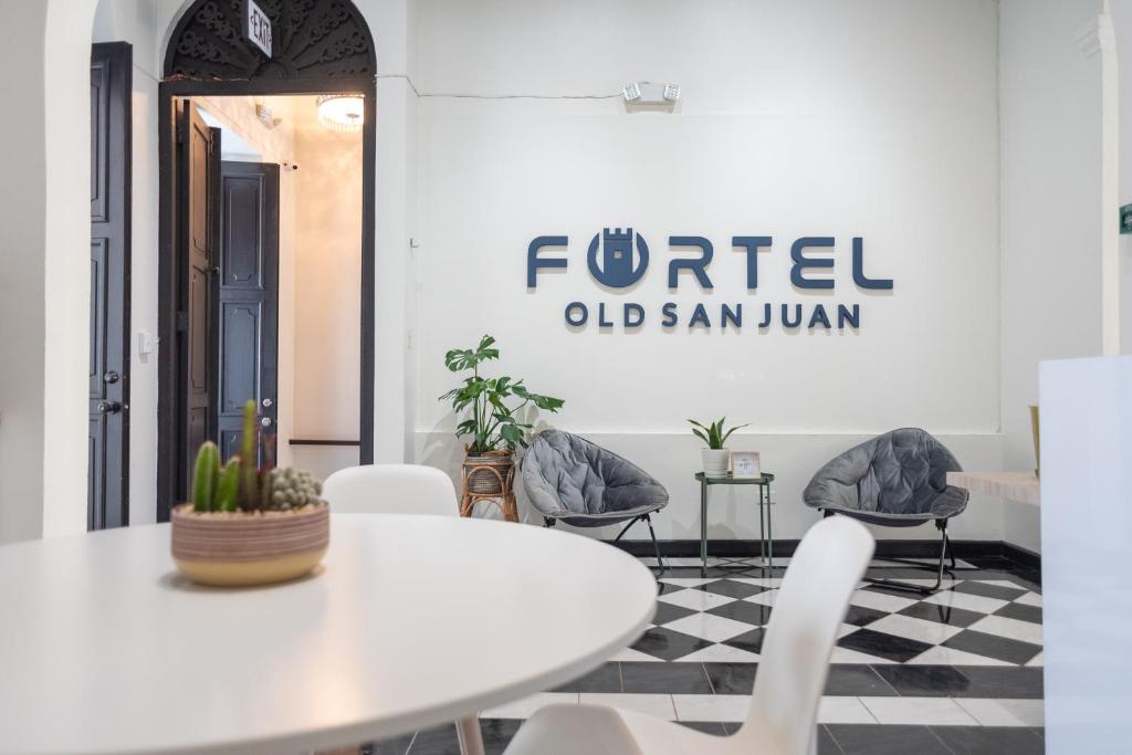 a living room with a table and chairs at Fortel Hostel in San Juan