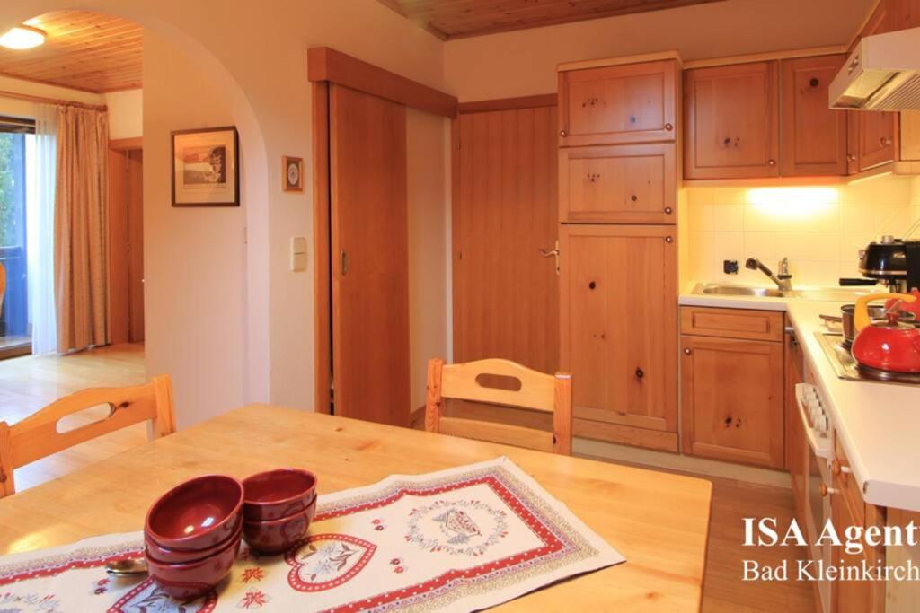 a kitchen with a wooden table and a kitchen with a counter at Apartment KATHREIN ski & spa in Bad Kleinkirchheim
