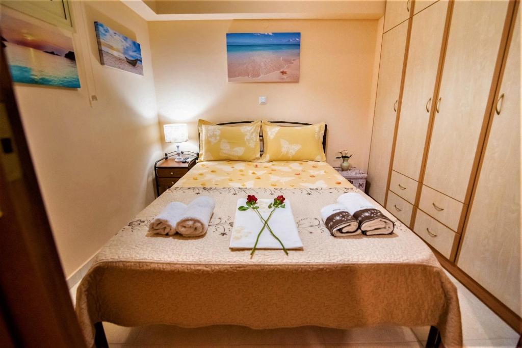 a small bedroom with a bed with shoes on it at Cantinetta in Preveza