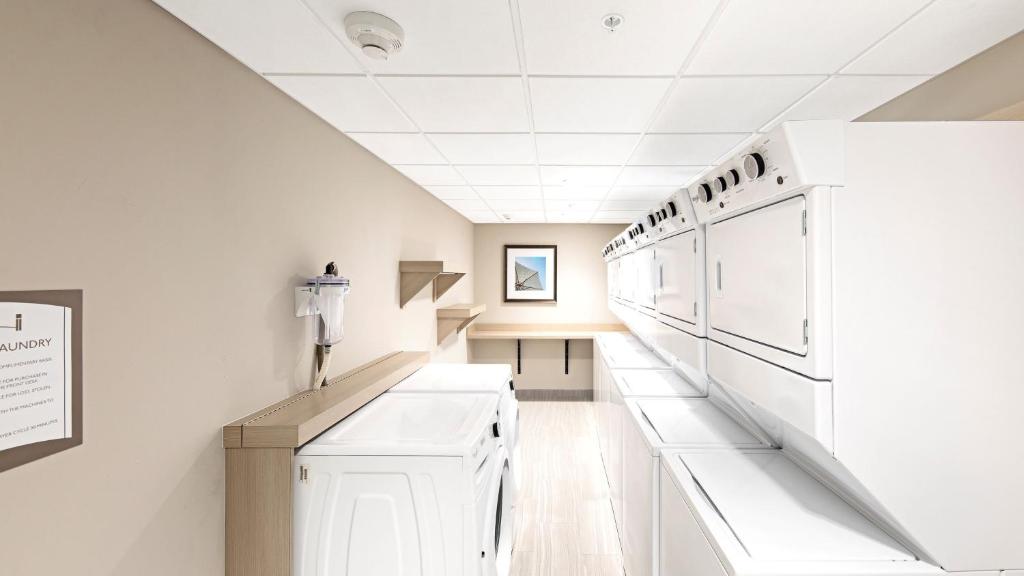 a kitchen with white cabinets and a ceiling at Staybridge Suites - Naples - Marco Island by IHG in Naples
