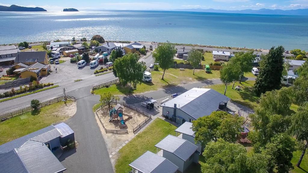 an aerial view of a small town next to the water at Marahau Beach Camp in Marahau