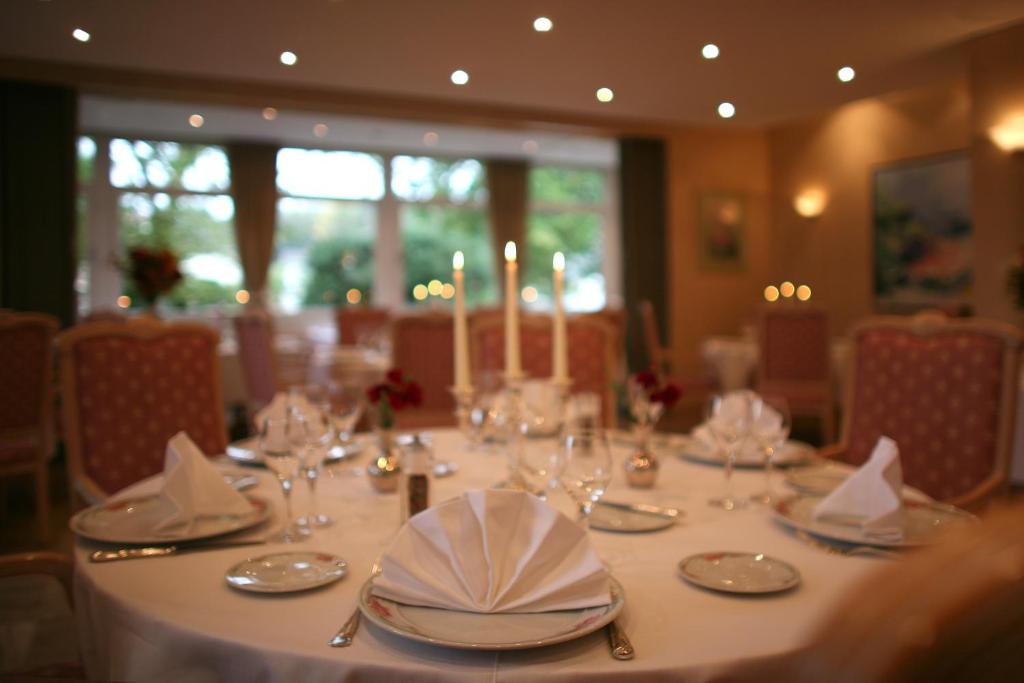 a table with plates and glasses and candles on it at Hotel Meyer in Beaufort