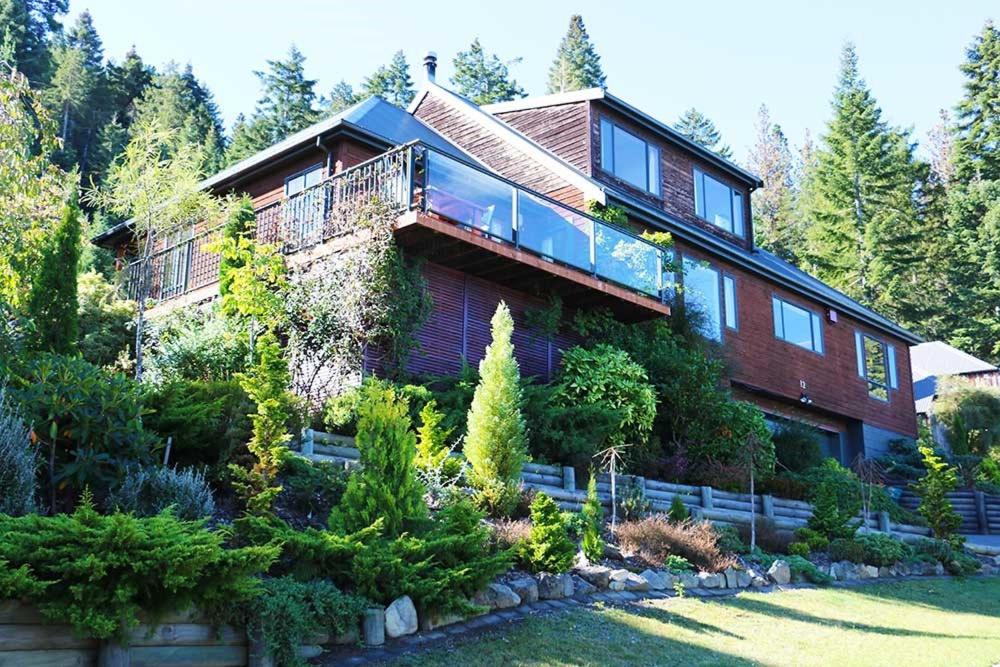 a large brick house with a garden in front of it at 12 Oregon Heights in Hanmer Springs