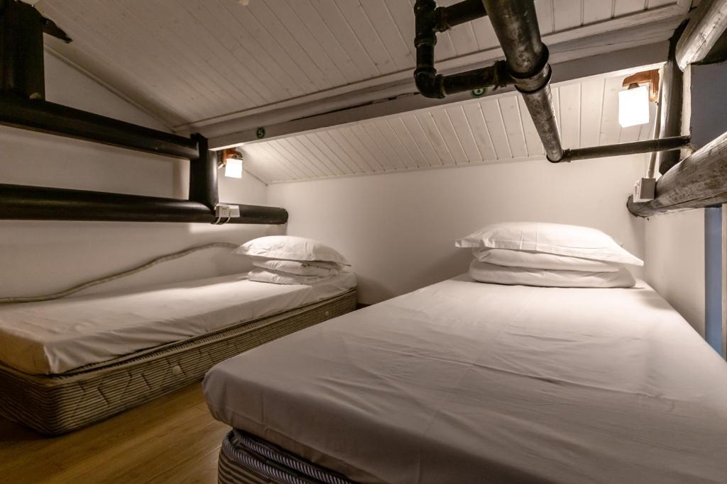 Postel nebo postele na pokoji v ubytování Hofang Guest House