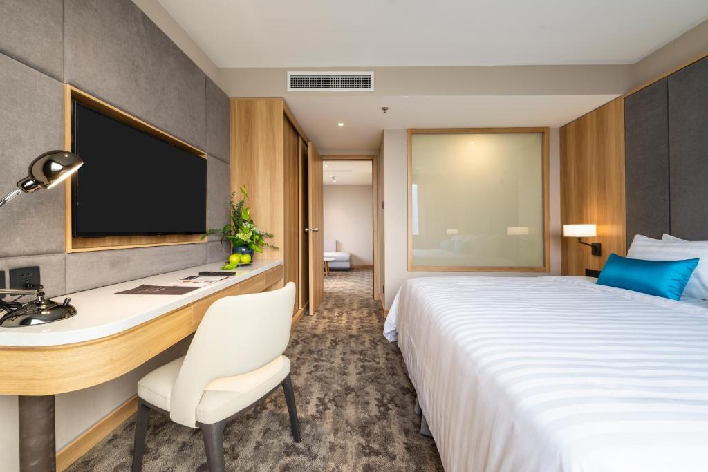 Postel nebo postele na pokoji v ubytování Hanoi Hotel
