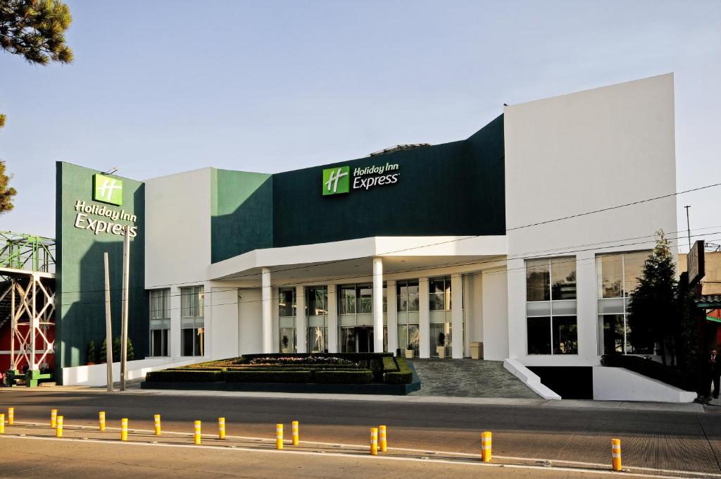 a building with a sign on the side of it at Holiday Inn Express Toluca, an IHG Hotel in Toluca