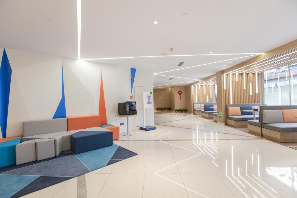 a lobby of a hospital with couches and a tv at Holiday Inn Express Xi'an Bell Tower, an IHG Hotel in Xi'an