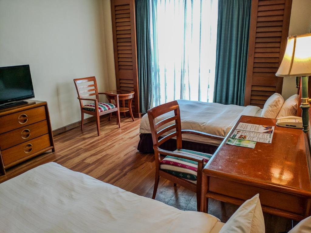 Postel nebo postele na pokoji v ubytování Sabah Oriental Hotel
