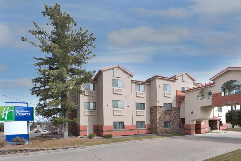 a apartment building with a sign in front of it at Holiday Inn Express Show Low, an IHG Hotel in Show Low