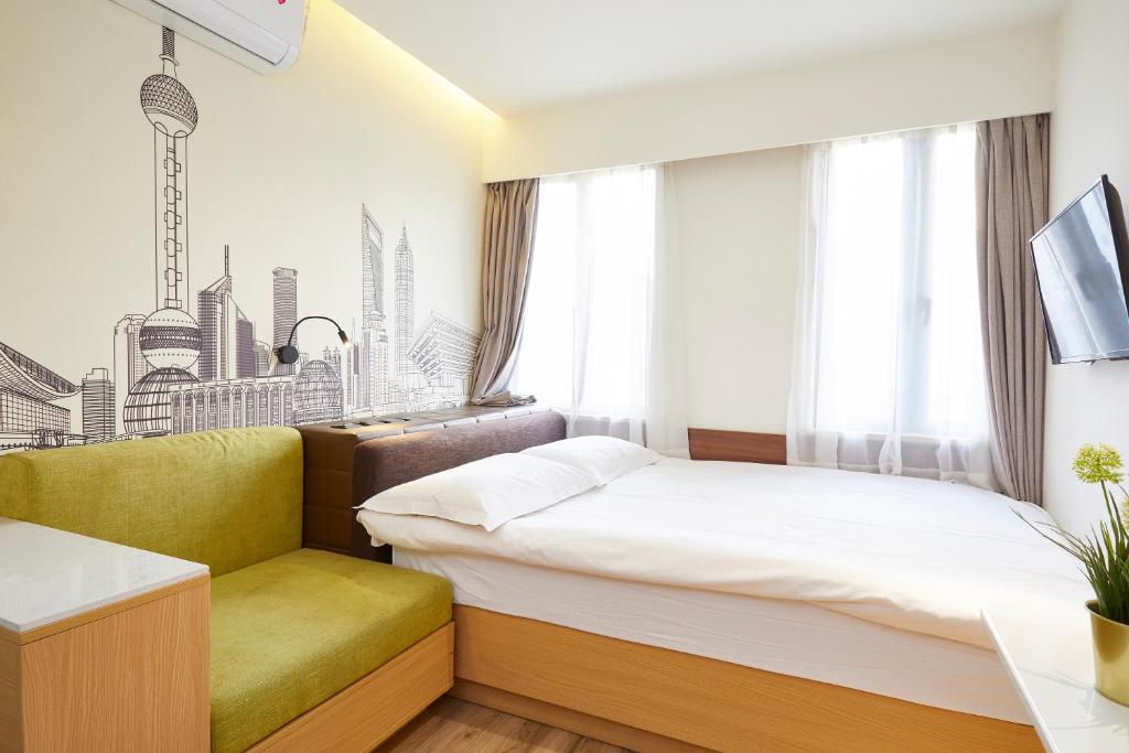 Postel nebo postele na pokoji v ubytování Shanghai Meego Qingwen Hotel