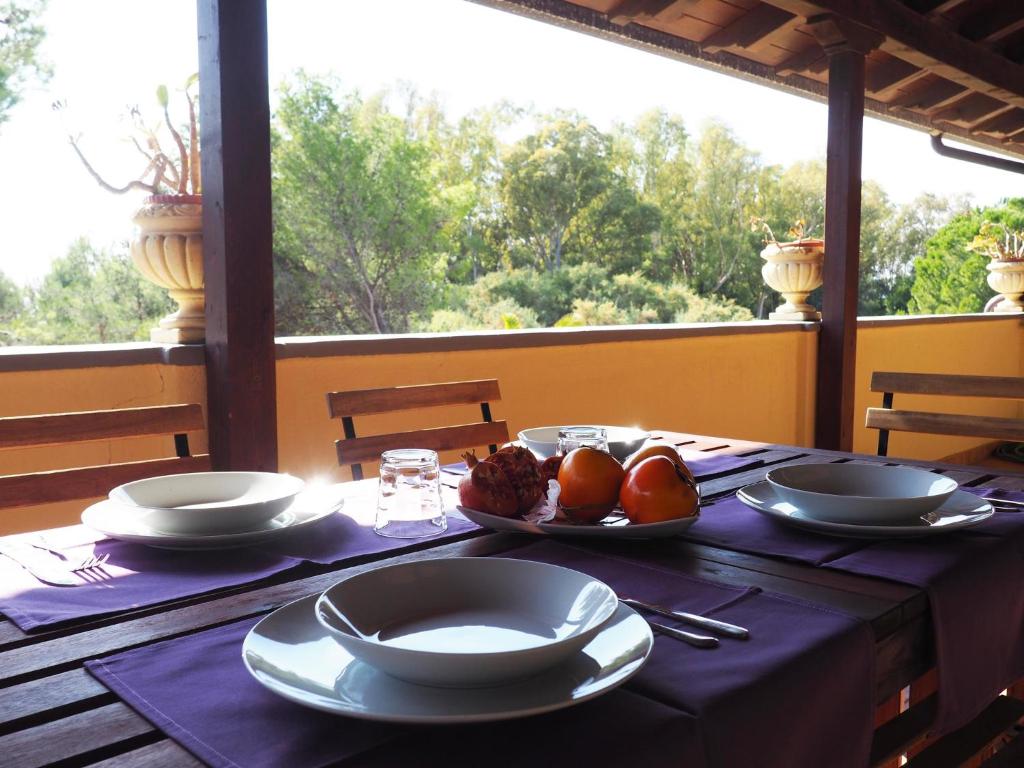 einen Tisch mit Teller und Schalen mit Früchten darauf in der Unterkunft Casa Vacanze De Grazia direttamente sul Mare in Botricello
