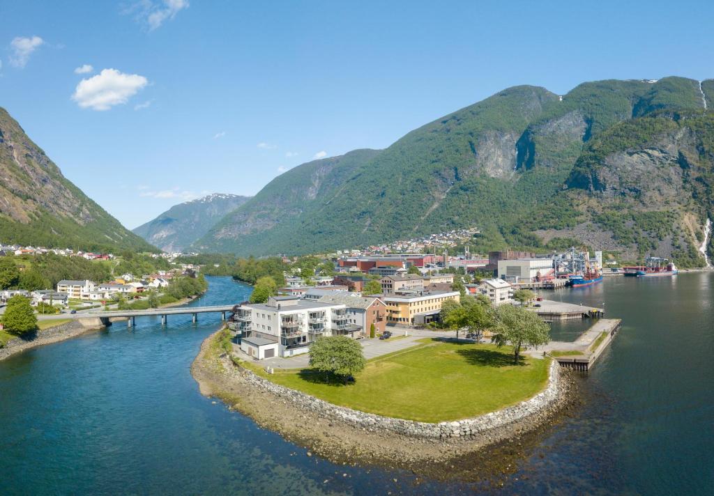 an aerial view of a town on a river with mountains at Klingenberg Hotel in Årdalstangen