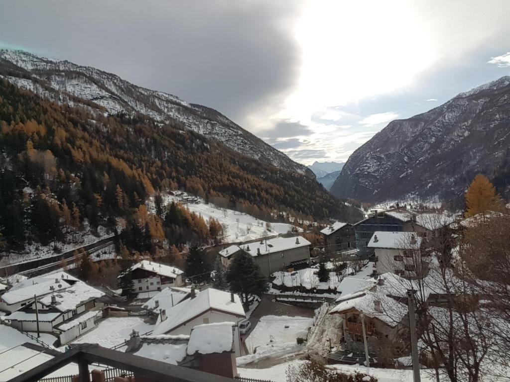 a village in the mountains with snow on the ground at Chez Ferdinand in Valtournenche