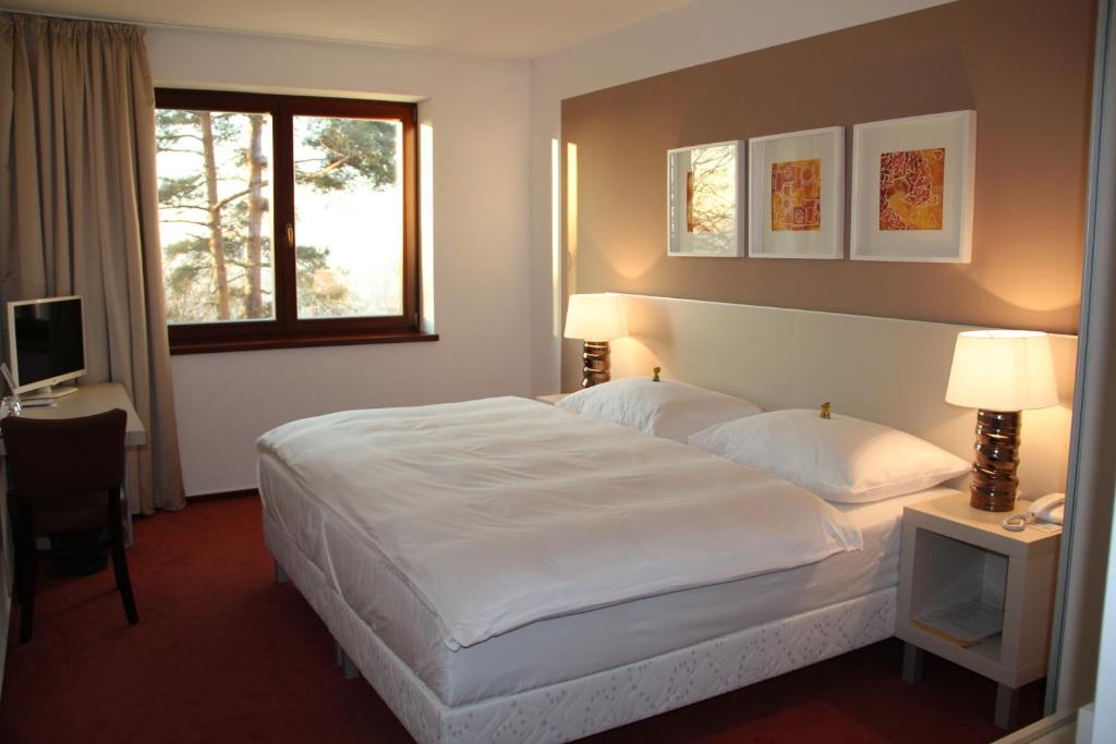Postel nebo postele na pokoji v ubytování Hotel Cvilín